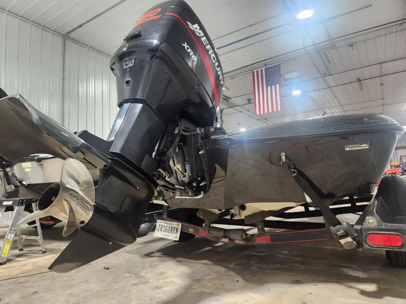 Slide: The Image of 2002 Ranger 185VS boat with Mercury XR6 engine in a garage setting. - 11