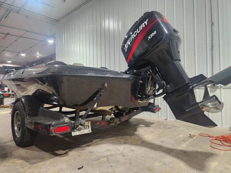 Slide: The Image of 2002 Ranger 185VS boat with Mercury XR6 outboard motor in a garage. - 12