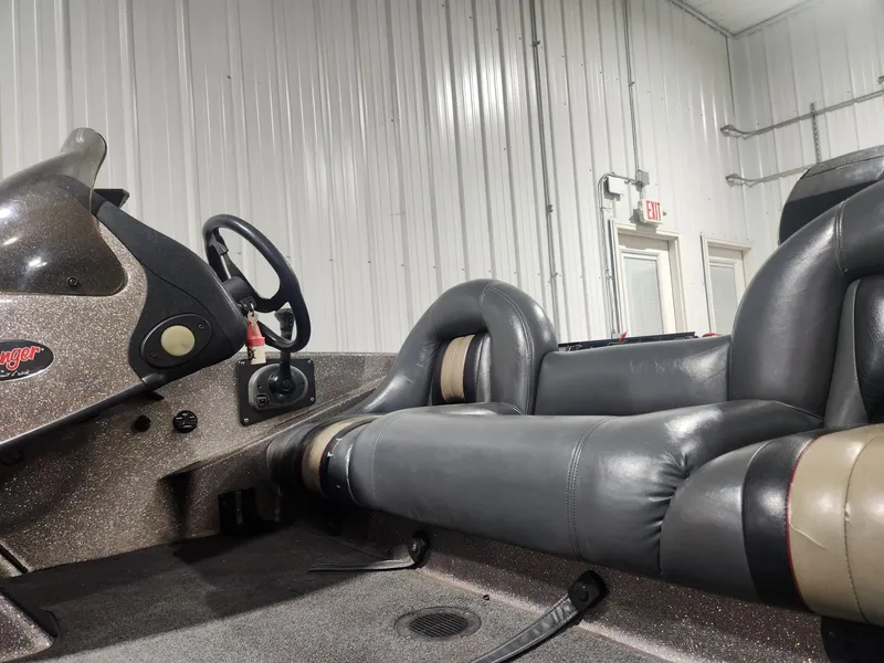Slide: The Image of 2002 Ranger 185VS boat interior with steering wheel and leather seats. - 13