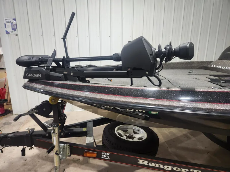 Slide: The Image of 2002 Ranger 185VS boat with Garmin trolling motor in a garage setting. - 14
