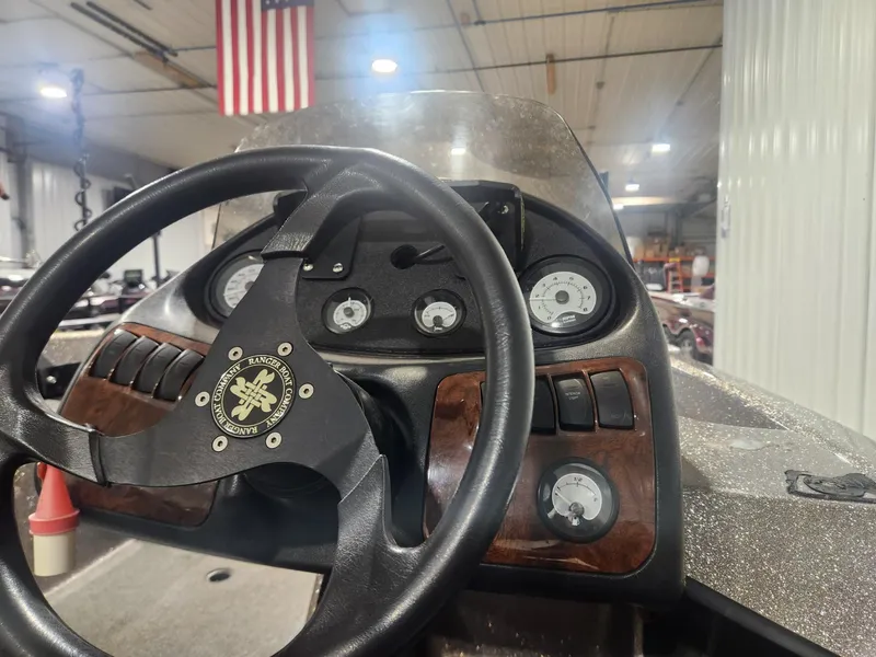 Slide: The Image of 2002 Ranger 185VS boat dashboard with steering wheel and gauges in a garage setting. - 16