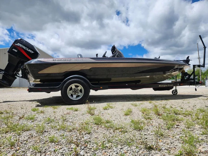 Slide: The Image of 2002 Ranger 185VS boat on trailer, outdoors under cloudy sky. - 4