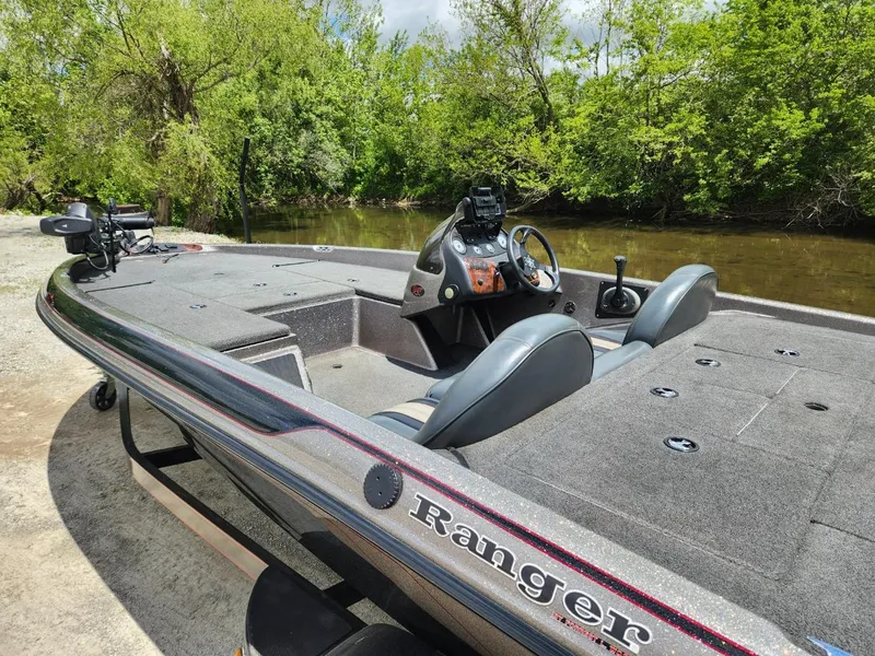 Slide: The Image of 2002 Ranger 185VS boat by a river, featuring dual seats and a sleek design. - 5