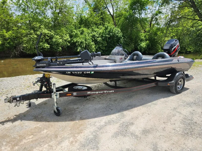 Slide: The Image of 2002 Ranger 185VS boat on trailer near a river, surrounded by trees. - 7