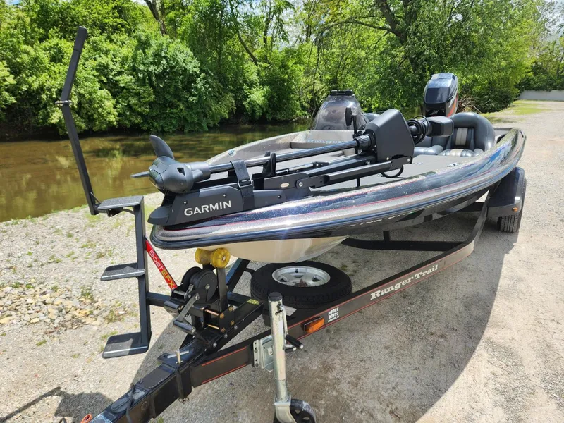 Slide: The Image of 2002 Ranger 185VS boat with Garmin equipment on a trailer by a river. - 8