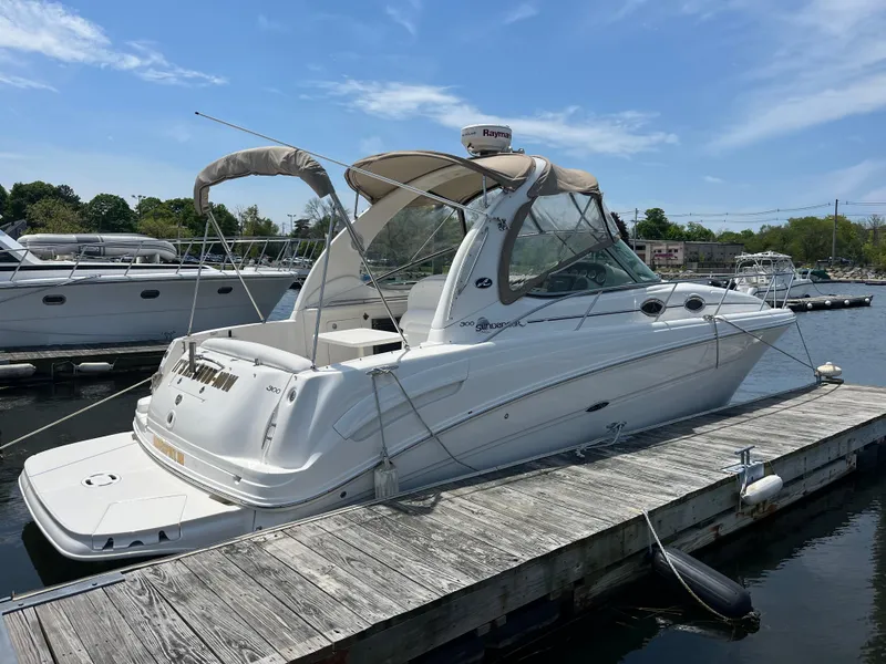 Slide: The Image of 2005 Sea Ray 300 Sundancer docked at marina under clear blue sky. - 0