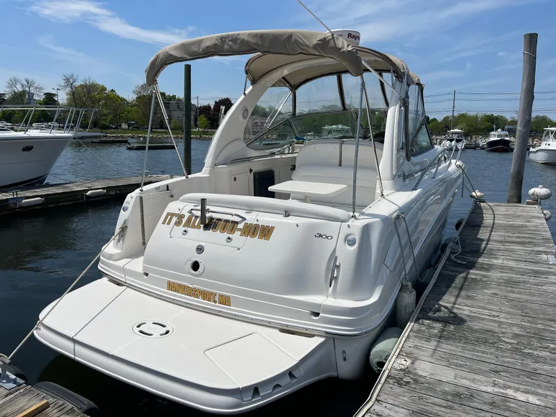 Slide: The Image of 2005 Sea Ray 300 Sundancer docked at marina under clear blue sky. - 1