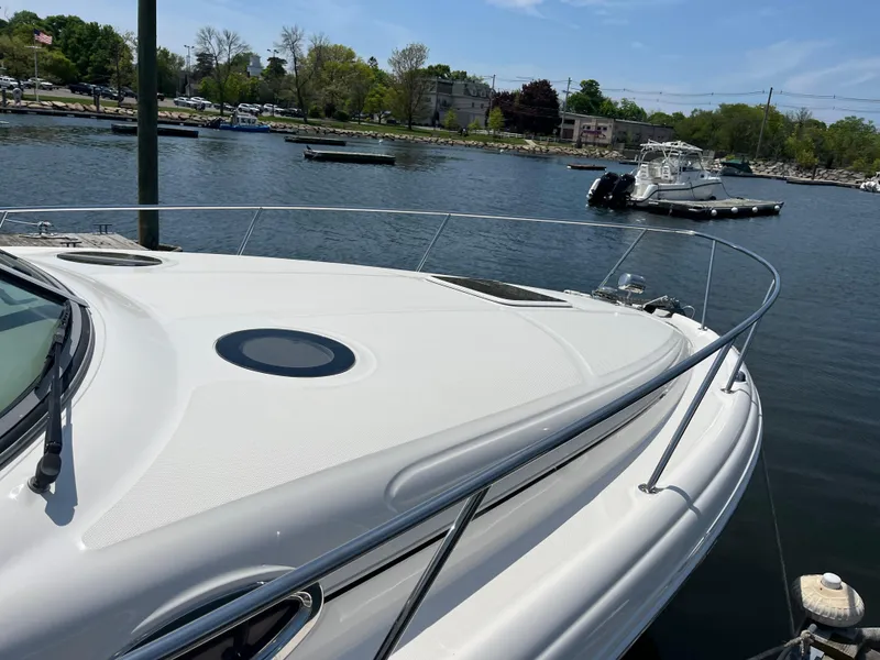 Slide: The Image of 2005 Sea Ray 300 Sundancer yacht docked in a serene marina setting. - 10