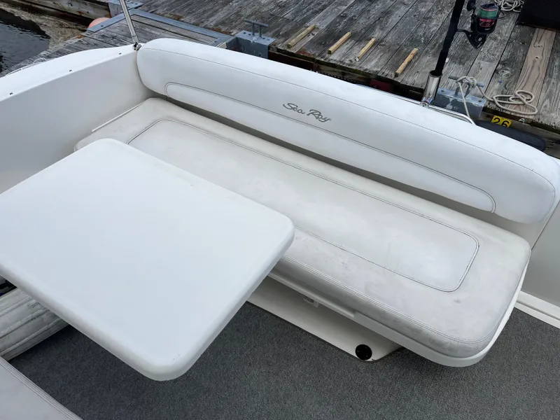 Slide: The Image of 2005 Sea Ray 300 Sundancer boat interior with white seating and table. - 11