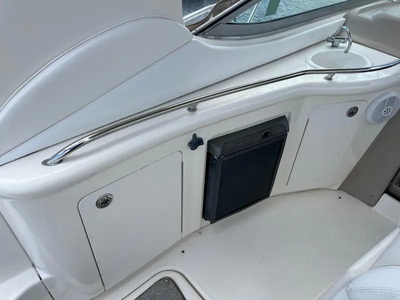 Slide: The Image of 2005 Sea Ray 300 Sundancer boat interior with sink and storage compartments. - 13