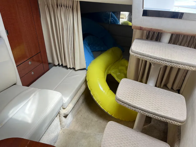 Slide: The Image of Interior of 2005 Sea Ray 300 Sundancer with seating, stairs, and inflatable pool toys. - 18
