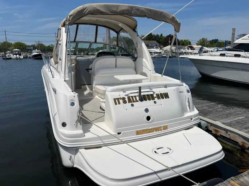 Slide: The Image of 2005 Sea Ray 300 Sundancer boat docked at marina, rear view. - 2
