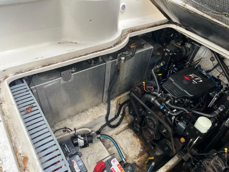 Slide: The Image of Engine compartment of a 2005 Sea Ray 300 Sundancer boat, showing mechanical components. - 23