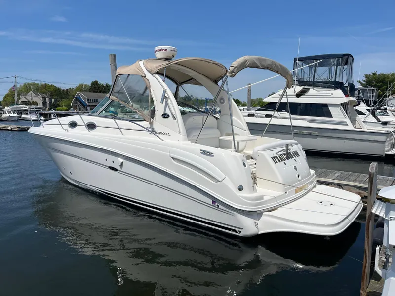 Slide: The Image of 2005 Sea Ray 300 Sundancer boat docked at marina under clear blue sky. - 3