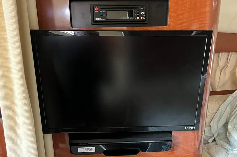 Slide: The Image of Vizio TV and stereo system inside 2005 Sea Ray 300 Sundancer boat cabin. - 31
