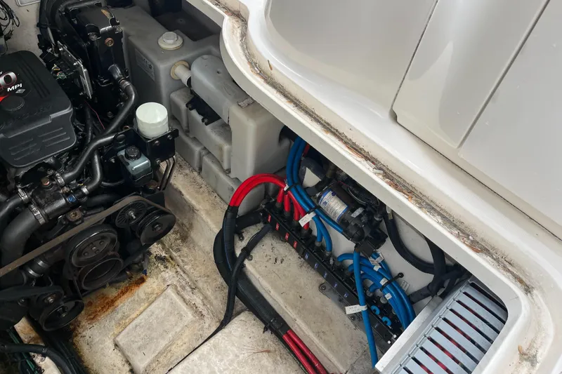 Slide: The Image of Engine compartment of a 2005 Sea Ray 300 Sundancer boat, showing mechanical components. - 35