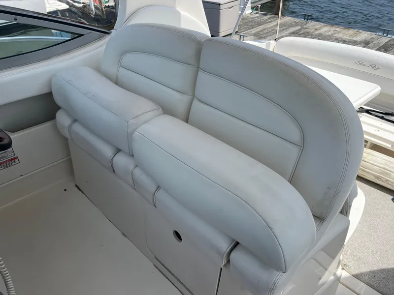 Slide: The Image of 2005 Sea Ray 300 Sundancer boat interior with white leather seating. - 7