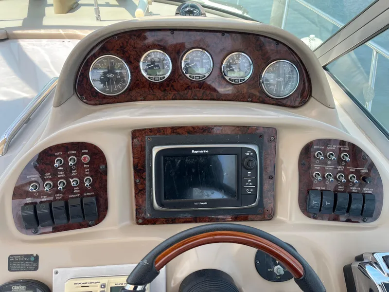 Slide: The Image of Control panel of a 2005 Sea Ray 300 Sundancer boat with gauges and navigation system. - 9