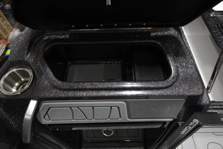 Slide: The Image of 2025 Yar-Craft 210TFX SP boat storage compartment with cup holder and sleek design. - 10