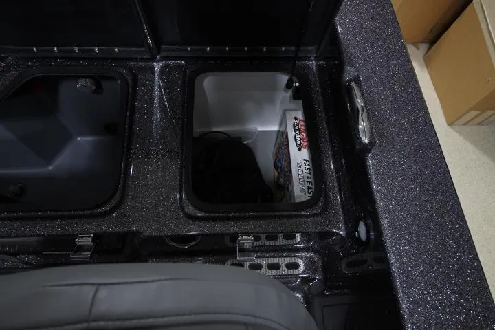 Slide: The Image of 2025 Yar-Craft 210TFX SP boat storage compartments with battery and equipment. - 18