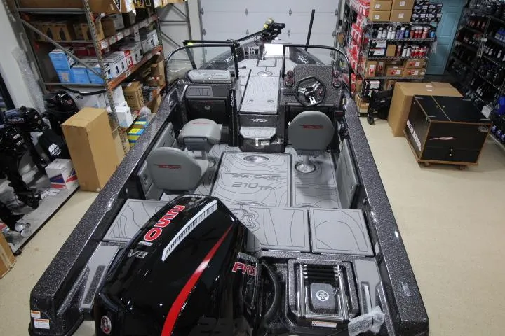 Slide: The Image of 2025 Yar-Craft 210TFX SP boat interior in a storage room, showcasing seating and equipment. - 3