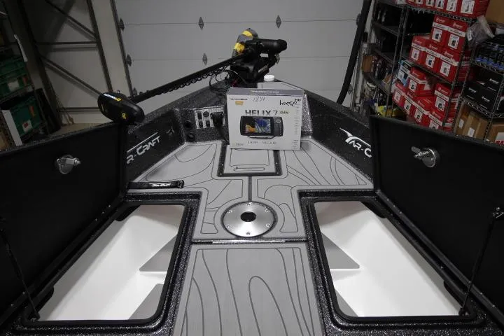 Slide: The Image of 2025 Yar-Craft 210TFX SP boat interior with advanced navigation system in a garage setting. - 4