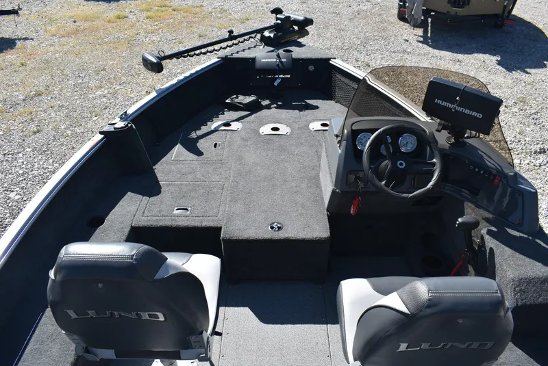 Slide: The Image of 2014 Lund 1675 Impact SS boat interior with steering console and seating. - 10