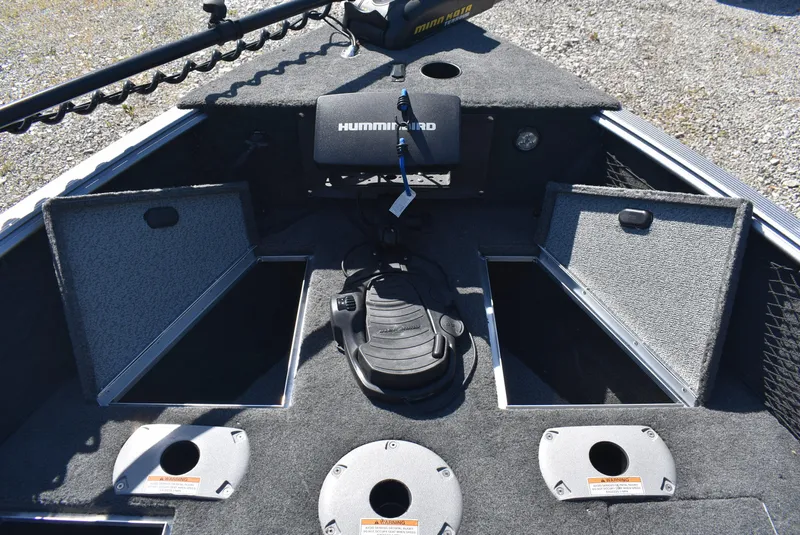 Slide: The Image of 2014 Lund 1675 Impact SS boat interior with storage compartments and Humminbird electronics. - 15