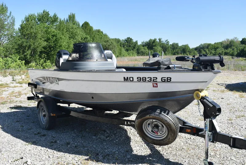 Slide: The Image of 2014 Lund 1675 Impact SS boat on trailer, parked outdoors on gravel. - 4