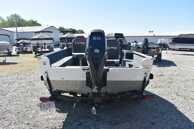 Slide: The Image of 2014 Lund 1675 Impact SS boat with 60 HP motor in a gravel lot. - 7