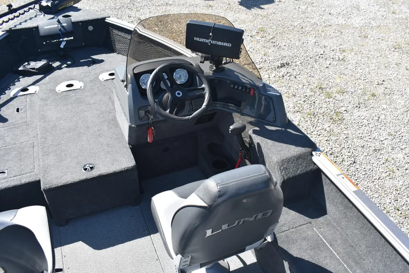 Slide: The Image of 2014 Lund 1675 Impact SS boat interior with steering wheel and Humminbird fish finder. - 8