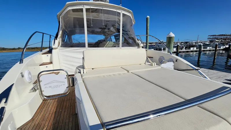 Slide: The Image of Azimut Atlantis 50 yacht, 2015 model, docked with spacious sunbathing area and clear blue sky. - 11