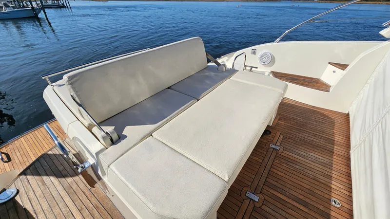 Slide: The Image of Luxurious seating on 2015 Azimut Atlantis 50 yacht with teak deck, overlooking serene waters. - 14