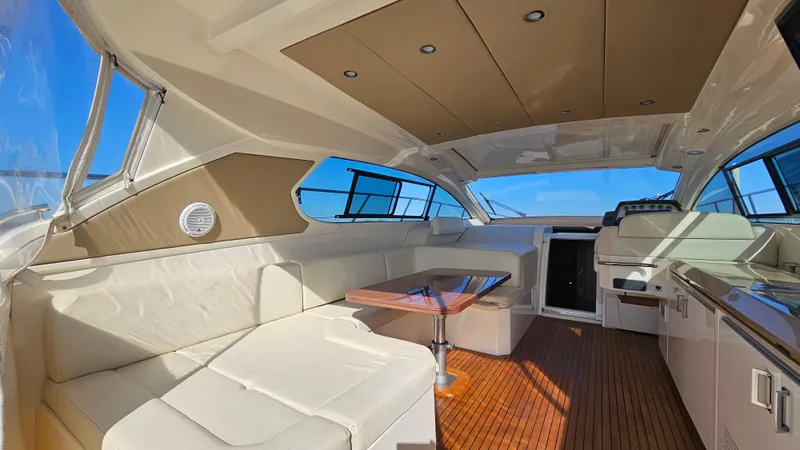 Slide: The Image of 2015 Azimut Atlantis 50 yacht interior with white seating, wooden flooring, and modern design. - 19