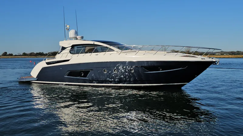 Slide: The Image of 2015 Azimut Atlantis 50 yacht cruising on calm waters under clear blue skies. - 2