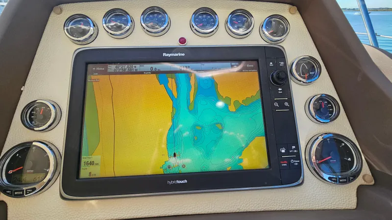 Slide: The Image of Dashboard of 2015 Azimut Atlantis 50 with navigation display and gauges. - 24