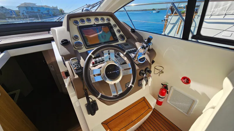 Slide: The Image of Cockpit of 2015 Azimut Atlantis 50 yacht with steering wheel and navigation controls. - 30