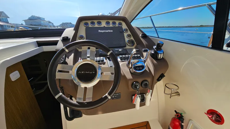 Slide: The Image of Helm of 2015 Azimut Atlantis 50 yacht with steering wheel and navigation controls. - 34