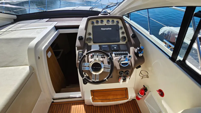 Slide: The Image of Helm of 2015 Azimut Atlantis 50 yacht with modern controls and wooden flooring. - 35