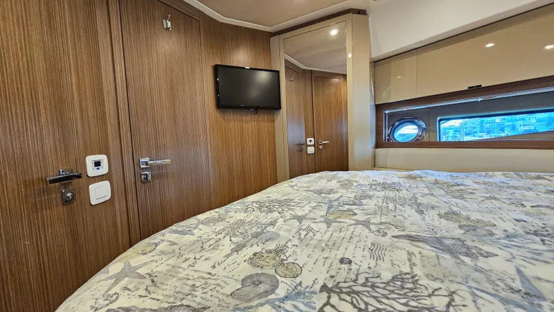 Slide: The Image of Luxurious cabin interior of 2015 Azimut Atlantis 50 yacht with wood paneling and porthole window. - 42