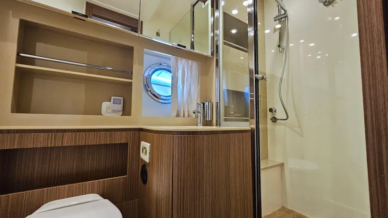 Slide: The Image of Luxurious bathroom in 2015 Azimut Atlantis 50 yacht with modern fixtures and wood accents. - 49