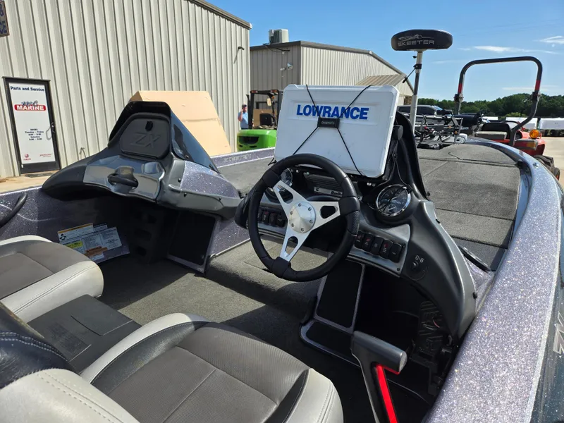 Slide: The Image of 2014 Skeeter ZX 20 boat interior with steering wheel and Lowrance navigation system. - 10