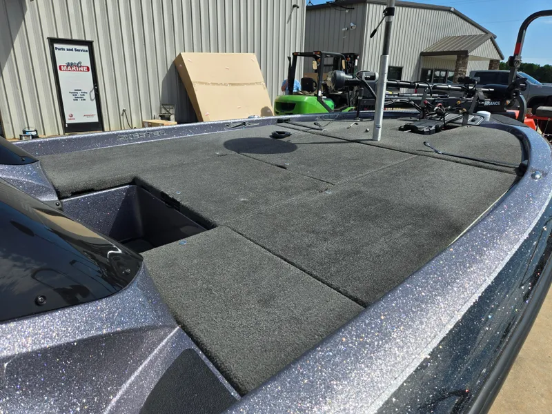 Slide: The Image of 2014 Skeeter ZX 20 boat deck with storage compartments and fishing equipment. - 12