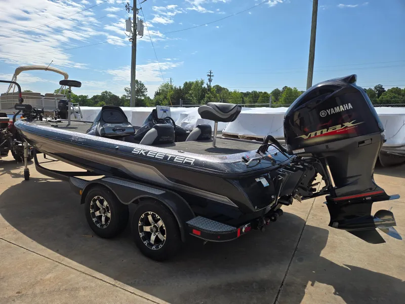Slide: The Image of 2014 Skeeter ZX 20 boat with Yamaha engine, parked on a trailer in a sunny outdoor setting. - 18