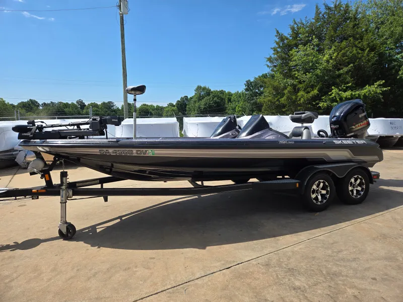 Slide: The Image of 2014 Skeeter ZX 20 bass boat on trailer, parked outdoors under clear sky. - 3