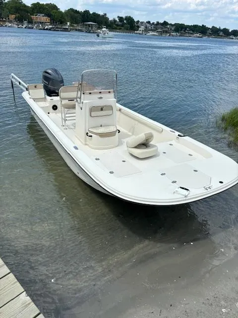 Slide: The Image of 2021 Carolina Skiff 23 LS boat docked by the shore on a sunny day. - 10
