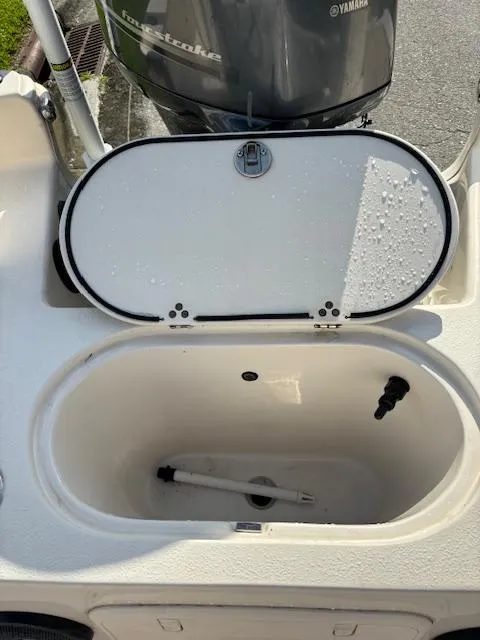 Slide: The Image of 2021 Carolina Skiff 23 LS livewell with open lid, showcasing interior features. - 11