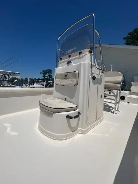 Slide: The Image of 2021 Carolina Skiff 23 LS boat console with seating, under clear blue sky. - 3