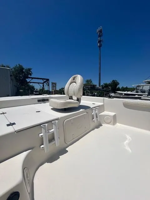Slide: The Image of 2021 Carolina Skiff 23 LS boat interior with seating under clear blue sky. - 4