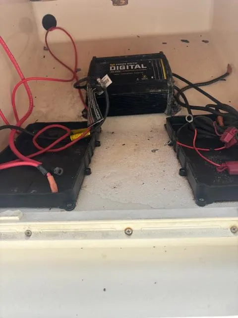 Slide: The Image of 2021 Carolina Skiff 23 LS battery compartment with wiring and digital charger. - 6